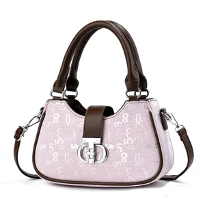 Pink digital print handbag with brown top handle and crossbody strap, detailed luxury design.