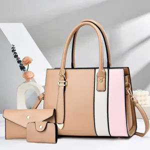 Detailed view of the chic color-block handbag set in khaki, white, and pink with gold hardware.