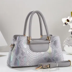 Detailed view of the luxury iridescent snakeskin tote bag with top handles and detachable strap.