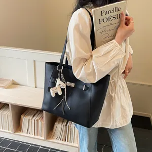 Detailed view of the black PU leather tote bag featuring elegant hardware and horse charm.