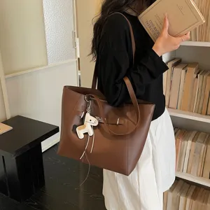 Elegant brown leather tote bag with lock detail, spacious shoulder bag for daily commuting.