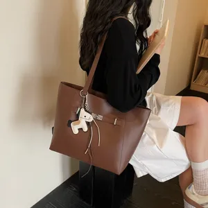 Stylish brown leather tote bag for women, large capacity shoulder bag for daily commute.