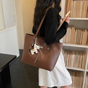 Elegant brown large capacity tote bag for women, stylish commuting single shoulder bag charm.