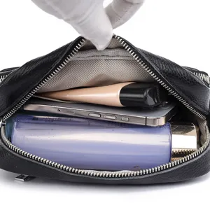 Black genuine leather crossbody bag, stylish camera bag with spacious interior storage.