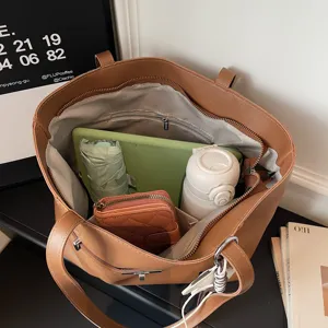 Large capacity brown tote bag for women, stylish commuter shoulder bag with practical inner pockets.