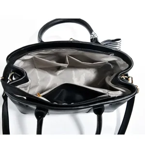Black women handbag interior detail, multi-compartment tote bag with stylish striped scarf.