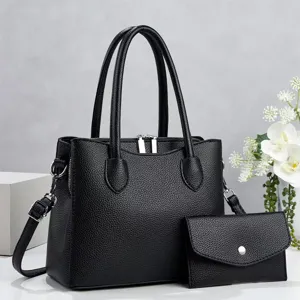 Elegante zwarte dames handtas set met handvatten en een handige bijpassende clutch.
