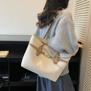 Detailed view of the women's commuter tote bag with contrasting straps and gold lock closure.
