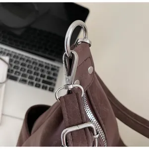 Brown vintage shoulder tote bag metallic hardware detail, silver tone rings and zipper.