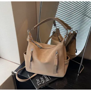Retro casual shoulder tote bag detail view, highlighting soft leather and zip pockets.