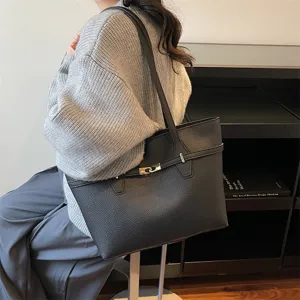 Black leather tote bag for women, stylish large capacity commuting shoulder bag with metal lock.