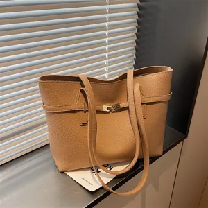 Vintage brown leather tote bag with stylish strap and lock design for women commuting.