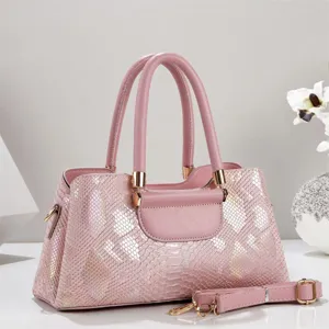 Pink laser snakeskin tote bag detail, featuring glossy metallic hardware and luxury texture.
