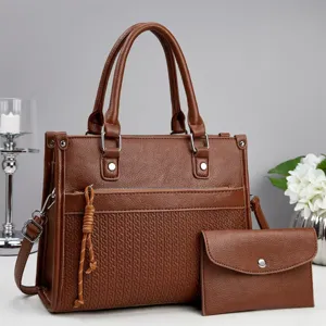 Detail view of stylish brown women handbag set with textured design and matching coin purse.