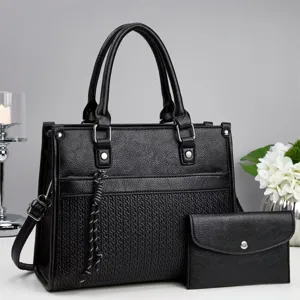 Elegant black women handbag and wallet set with textured design, top handles and shoulder strap.