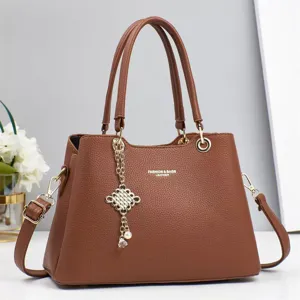 Detailed view of women brown leather handbag showcasing fine texture and premium hardware.