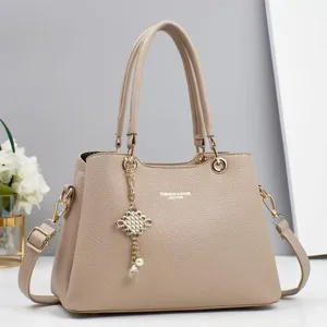 Stylish women's casual large capacity shoulder handbag with chic pearl charm, elegant leather.