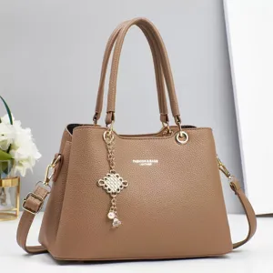 Detailed view of women handbag pendant strap hardware texture fashion casual style everyday use.
