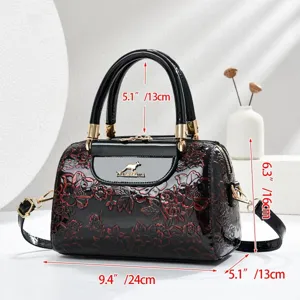 Black patent leather embossed floral handbag with top handle and crossbody strap dimensions