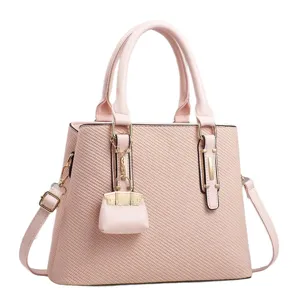 Elegant pink women handbag tote bag with detachable shoulder strap and chic mini charm.
