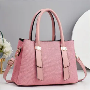 Fashion pink textured shoulder handbag for women, casual tote bag with elegant handle style.