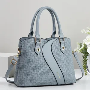 Stylish grey woven patchwork crossbody handbag with top handles and gold hardware details.