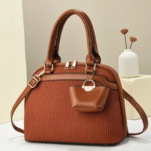 Brown women handbag chic shoulder crossbody bag with unique pleated texture and small pouch charm.