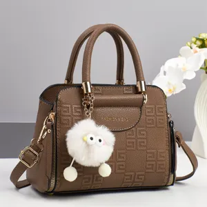 Brown large capacity women shoulder handbag with debossed geometric patterns and plush charm.