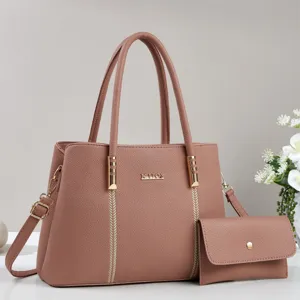 Stylish women's leather handbag and crossbody bag set with top handles and chic metallic decor.