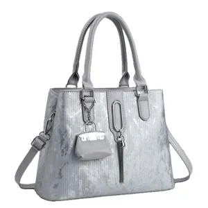 Stylish grey women tote bag, versatile shoulder crossbody handbag with chic mini pouch charm.