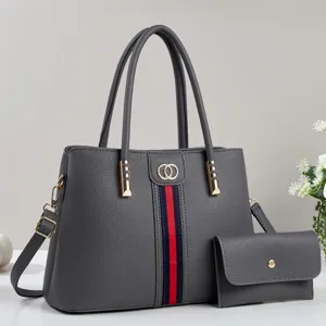 Gray pebble leather tote bag detail with red blue web stripe, dual handles and matching pouch