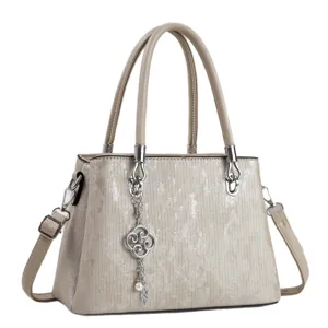 Stylish women handbag with top handle and shoulder strap, elegant metallic textured design.