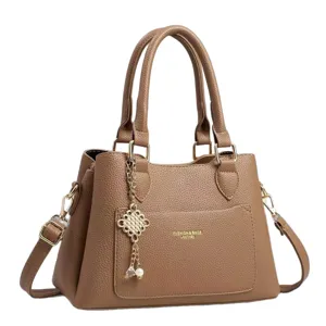 Classic brown leather handbag for women, elegant top-handle shoulder messenger bag with charm.
