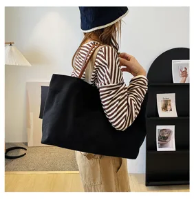 Minimalist black canvas tote bag for women, large capacity casual shoulder bag daily commuter.