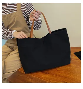 Large capacity canvas tote bag for women, simple casual commuter handbag with brown handles.