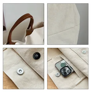 Detailed view of casual canvas tote bag, showing sturdy handles, magnetic snap, and durable fabric.
