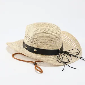 Detail view of a stylish straw cowboy hat with black leather band, stars, and brown chin cord.
