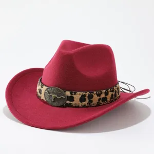 Close-up view of red felt cowboy hat with leopard leather band and vintage metal bull skull.