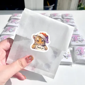 Cute Christmas tiger thank you stickers in translucent packaging for holiday gifts and seals.