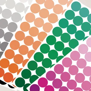 Detailed closeup shot of colorful round dot stickers sheets, ideal for notebook indexing.