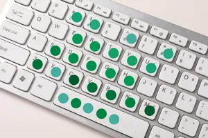 Close-up detail of colorful round dot index stickers applied on keyboard keys for daily use.