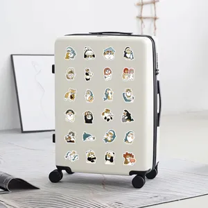 Detailed scene showing cute cartoon cat stickers decorated on a stylish white suitcase.