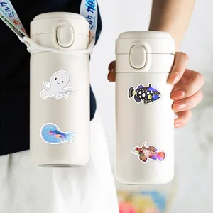 Stainless steel thermos water bottle with cute marine animal stickers and portable strap.