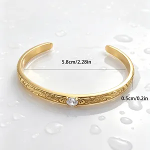 Vintage style Hawaiian vine pattern open cuff bracelet in gold plated titanium steel detail view.