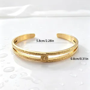 Detailed view of the gold-plated stainless steel Hawaiian vine cuff bracelet close-up.