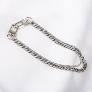 Stainless steel double layer cuban chain detail shot, sleek metal pants chain accessory.