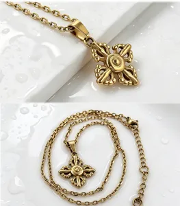 Close-up detail of the cross vajra pendant necklace, showcasing fine metallic texture.