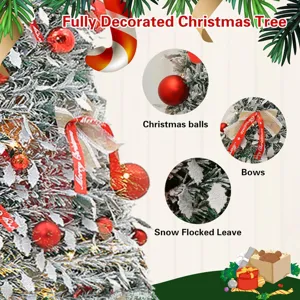 Decorated Christmas tree set with snow flocked leaves, red balls and bows for holiday.