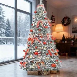 Artificial Christmas tree with snow, red ornaments, and warm lights for holiday home decor.