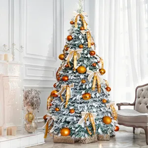 Detailed view of the decorated Christmas tree with golden ornaments and snow flakes in room.